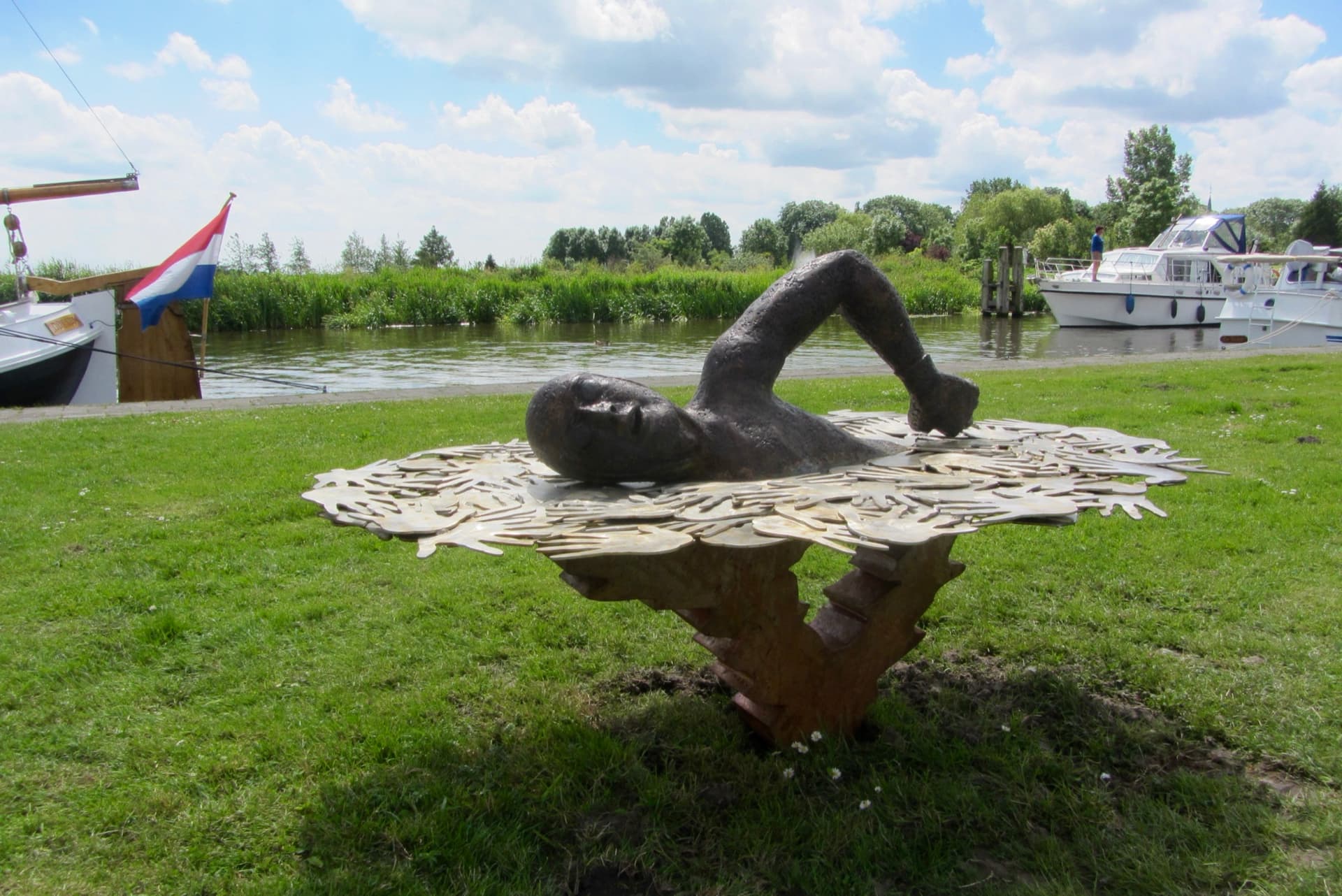Statue of Maarten swimming beside the water in Burdaard, where his first Elfstedentocht attempt ended